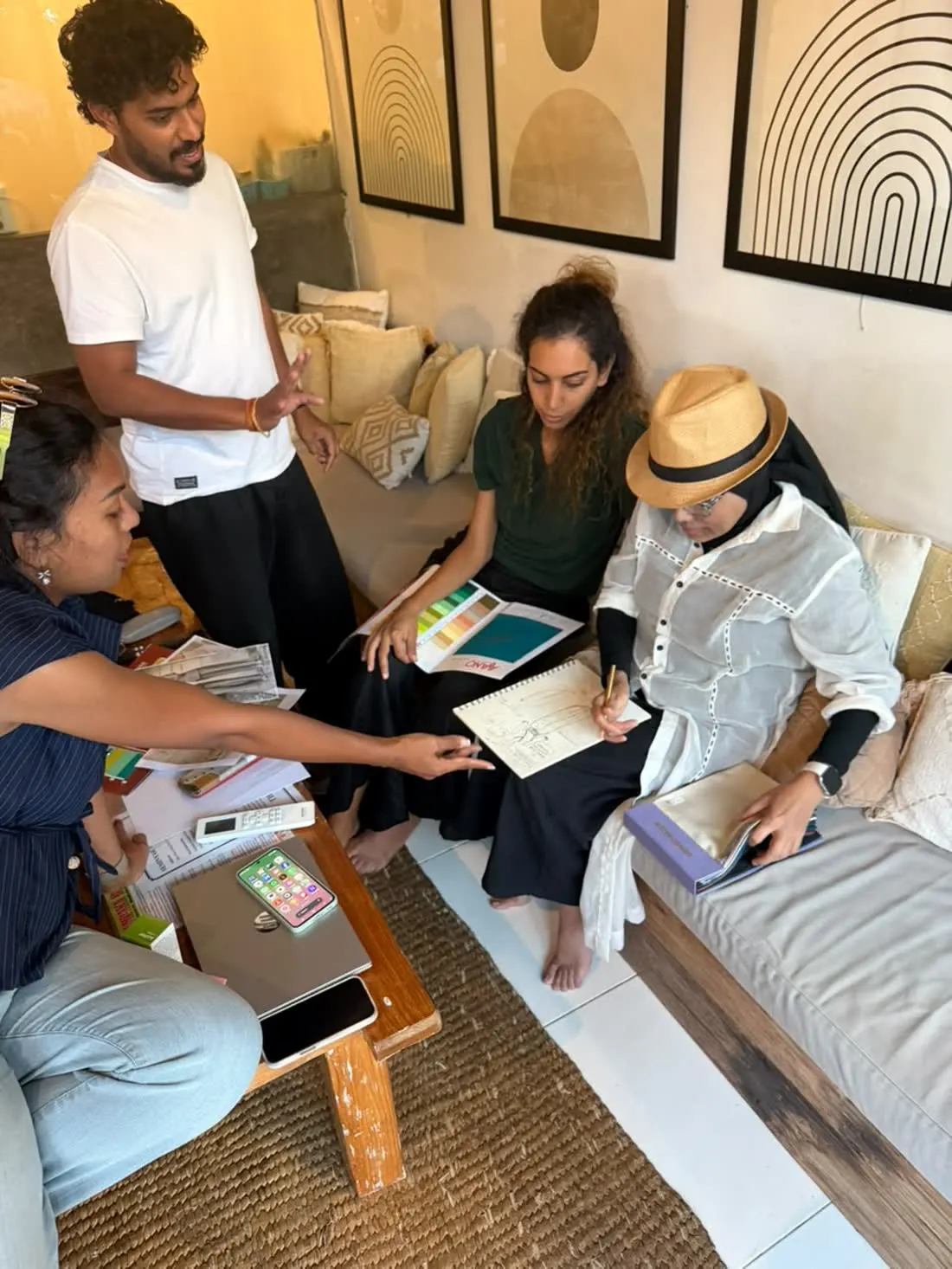 The Raha team sketching uniform designs and reviewing colour swatches in Bali